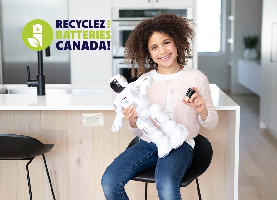 Kid recycling her used batteries
